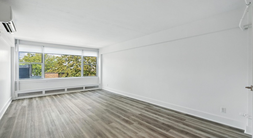 unfurnished living with large windows 